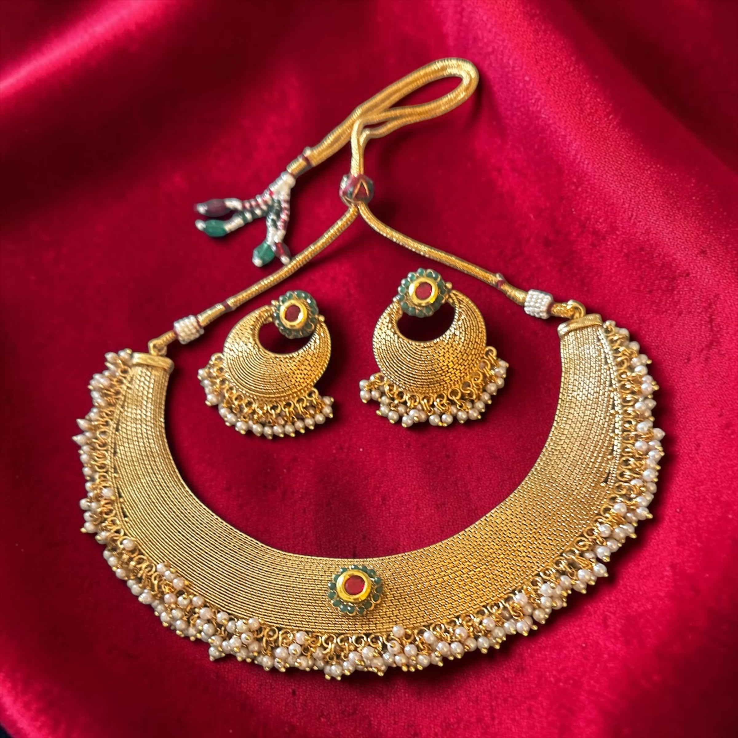 Ruby n green stone set in gold finish
